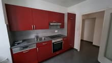 Red cabinets, stainless steel appliances, granite countertop, modern kitchen design
