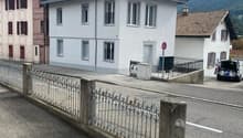 Building, red tiled roof, glass windows, metal fence, driveway