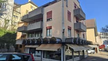 3 story building, balconies, awnings, storefront