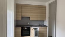 modern wooden cabinets, granite countertop, stainless steel sink, oven, refrigerator