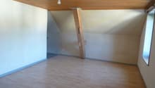 empty room, wooden beam, electrical outlet, wooden floor, windows, ceiling lamp