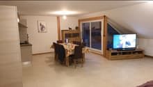 dining table with chairs, flat screen tv, wooden tv unit, white ceiling, tiled floor