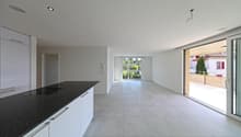 modern kitchen, tile flooring, sliding glass doors, large countertop, white cabinets, balcony