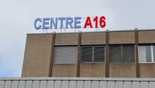 A multi-story commercial building with the sign 'CENTRE A16' displayed prominently on the facade.