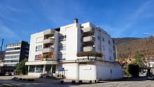 modern multi-story apartment building, balconies on multiple floors, modern architecture, clear sky
