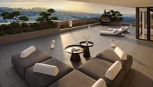 Outdoor terrace with lounge chairs, tables, and a view of the mountains
