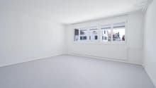 white walls, white floor, large windows, modern radiator, view to street