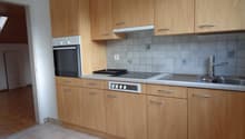 Spacious kitchen with wooden cabinets, tiled backsplash, built-in oven, and dishwasher