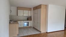 a kitchen with wooden countertops, an oven, a refrigerator, and a washing machine