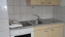kitchen with oven, sink, cabinets, tiled floor