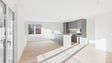 open plan living room and kitchen, large windows, balcony, hardwood floor, gray cabinetry