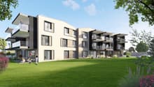 3-story modern apartment building with clean, minimalist design, large windows, and balconies. The building is surrounded by a well-manicured lawn and landscaping.