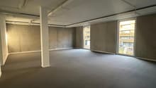 empty room, concrete walls, glass windows, gray carpet