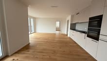 Empty room with wooden floor, white walls, glass doors, white kitchen cabinets, black oven, white ceiling