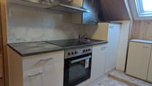 kitchen with white cabinets, tiled floor, granite countertop, gas stove, oven, sink, faucet, wooden ceiling