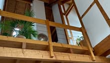 wooden ceiling, wooden floor, balcony with wooden railing and plants