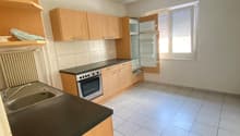 empty kitchen, white tiles, wooden cabinets, counter, sink, oven, refrigerator