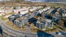 Residential apartment buildings with green roofs, parking, modern architecture, central location, green areas and trees