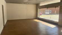 Open room, wooden floor, glass window with a view of a road