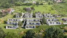 Modern apartment complex with green roofs, balconies, and raised ground floors