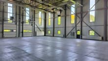 large open space, metal beams, large windows, concrete floor, industrial look
