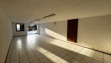 empty room, white tiles, fluorescent lighting, doorway