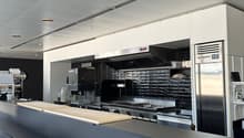 modern commercial kitchen, stainless steel appliances, tiled backsplash, commercial oven, refrigerator