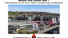 Commercial building with many retail stores and a parking lot in front of it
