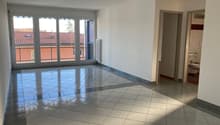 empty room, tiled floor, large windows with balcony, white walls, radiators, door to the right