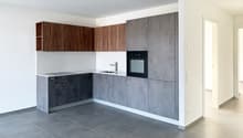 modern kitchen with gray cabinets, white countertops, black oven, wooden shelves, tiled floor