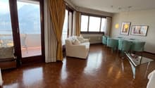Living room, wooden floor, balcony, glass windows, dining table, white sofa