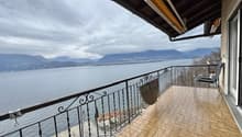 wooden tiled floor, balcony rail, chair, lake view, mountains