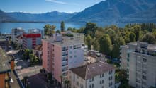 Buildings in a town near a lake and mountains