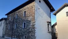 2 story house, stone exterior, white interior, multiple windows, balcony on second floor
