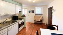 kitchen, wooden floor, white cabinets, sink, oven, window, lamps