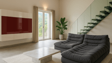 wooden ceiling, white tiles, gray sofa, white rug, marble coffee table, white cupboard with red doors, stairs with glass steps, balcony with metal railing
