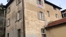 4 story house, tan walls, white shutters, red door, stairs