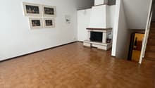 white walls, brown tiles, fireplace, staircase, artwork