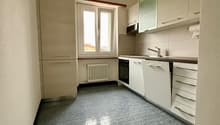 White kitchen with tile floor, white cabinetry, under cabinet lighting, window, stainless steel appliances
