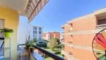 balcony, railing, plant pots, wind spinner, distant buildings, greenery, blue sky