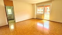 empty room, wooden parquet flooring, sliding glass doors, radiator, ceiling fan