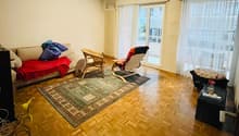 Empty room, white walls, wooden floor, curtains, windows, carpet, wicker chairs, and sofa
