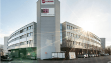 Multi-story office building with Growa and SBI Software Beratungs-Institut AG logos, parking spaces in front of the building