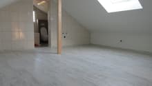 empty attic room, white tiles, wooden floor, skylight, toilet, small window