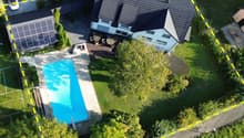 detached house, modern design, swimming pool, solar panels, paved driveway, trees, lawn