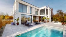Modern white house, two stories, large windows, pool, outdoor seating area, potted plants