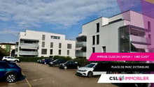 modern multi-storey building, outdoor parking, white exterior, multiple windows