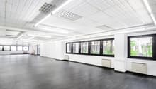 empty room, white walls, black tile floor, white suspended ceiling, large windows, radiators