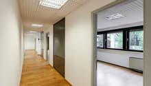 wooden floor, white walls, multiple windows, open glass door