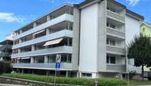 Multi-story apartment building, balconies, concrete exterior, modern design
